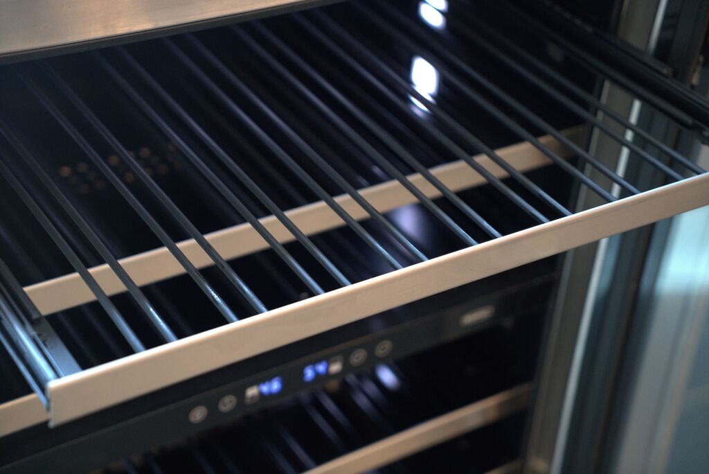Marvel MRWC215-IG31A Wine Refrigerator interior showing matte black finish, stainless steel wire racks, and multi-point LED lighting